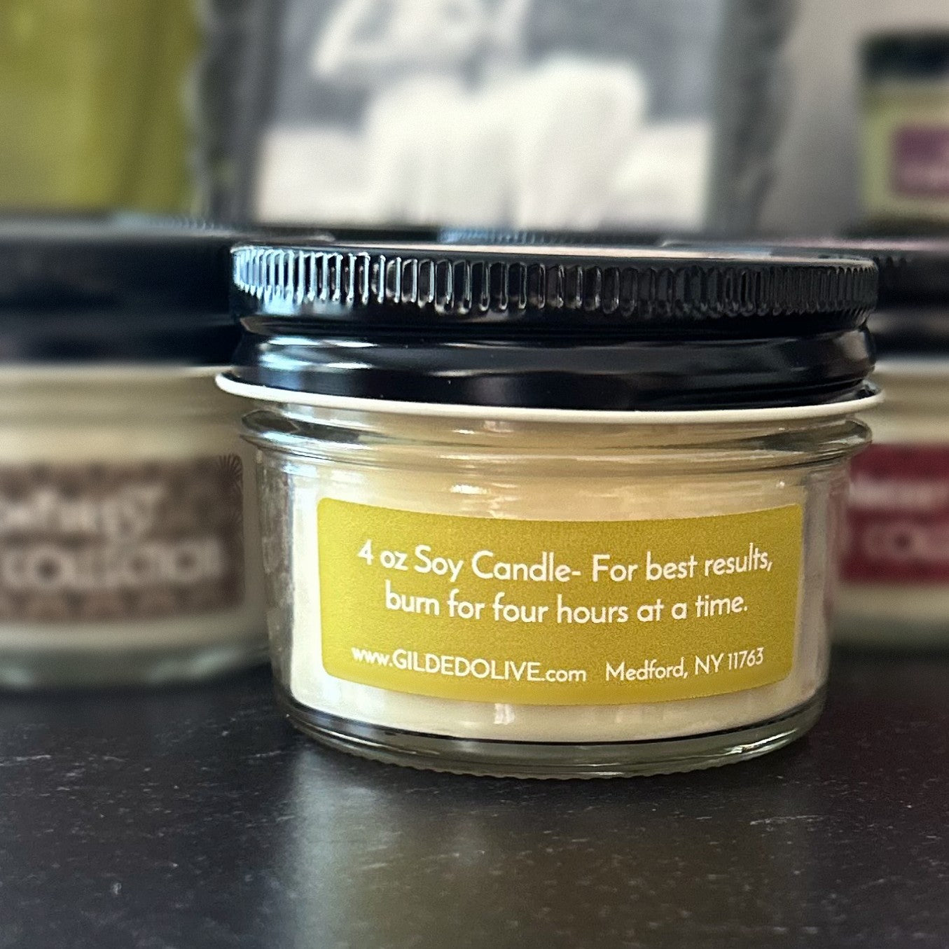 4 oz soy candle jar, showing a back label with burning instructions.