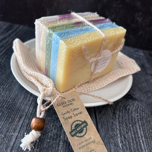 A bundle of 5 soap ends tied with twine, and  a cotton soap saver bag.