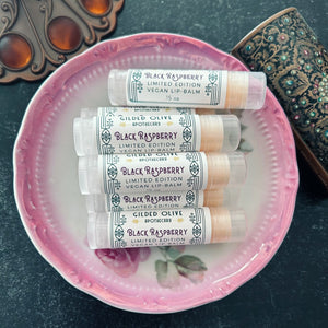 Black Raspberry Lip Balms arranged in a pink vintage bowl.