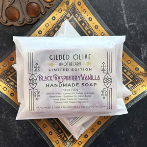 Gilded Olive Apothecary Limited Edition Black Raspberry Vanilla Handmade Soap, placed on an antique  dish.