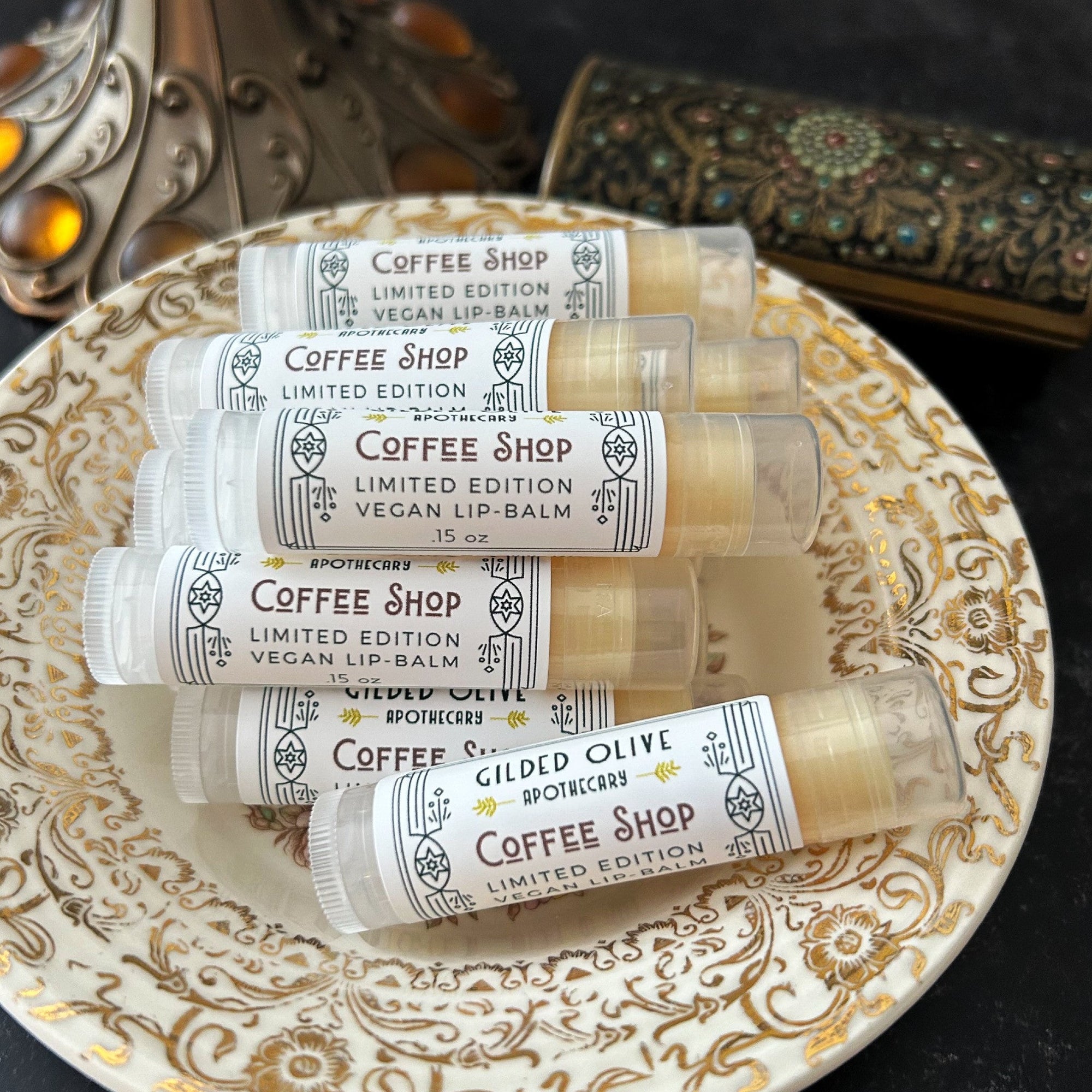 Coffee Shop Lip Balms in a vintage dish on a dark background
