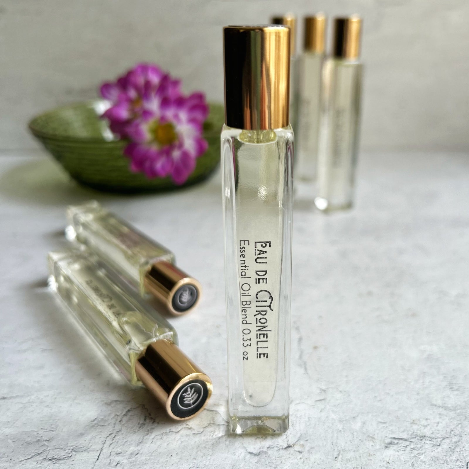 Eau de Citronelle Rollerball Perfume with a pink blossom