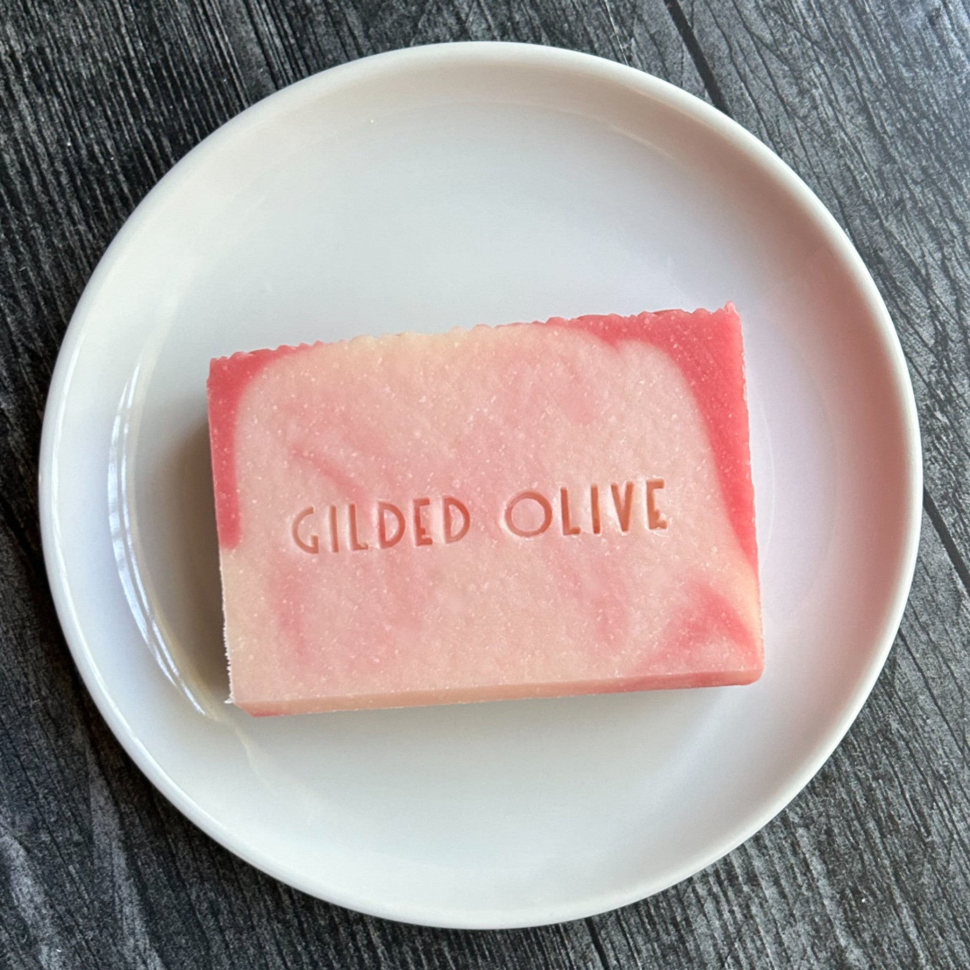 Grace handmade soap, on a white dish stamped with the Gilded Olive name