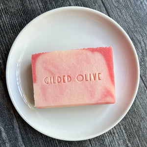 Grace handmade soap, on a white dish stamped with the Gilded Olive name