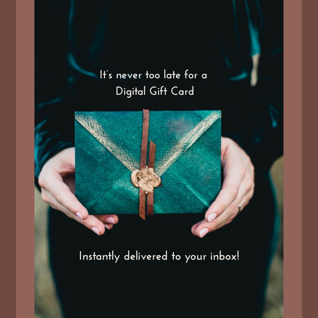 Teal gift card with brown ribbon held by hands against a dark background