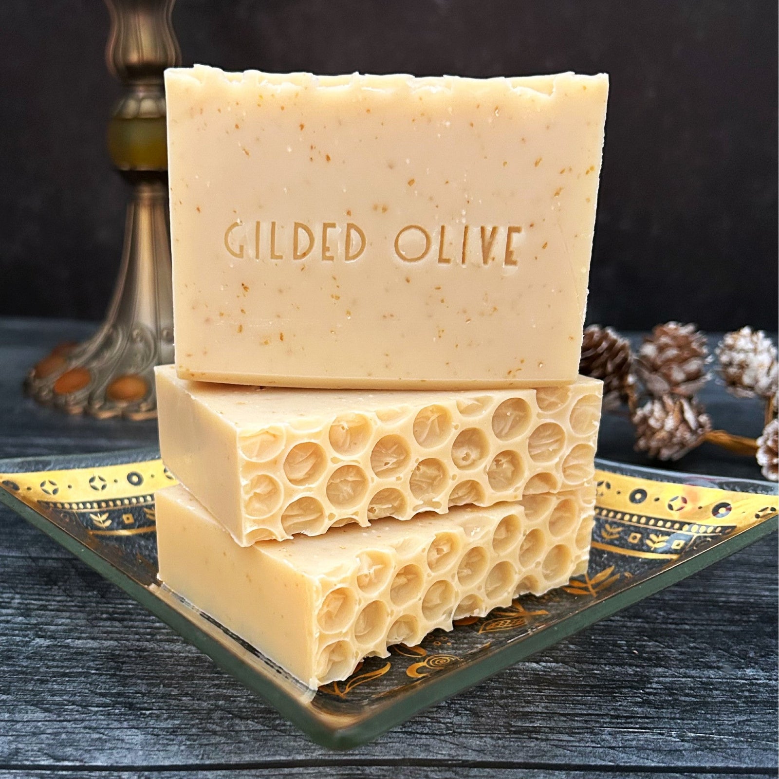 Oatmeal Milk Honey Handmade Soap with a honey comb design stacked on a vintage dish.