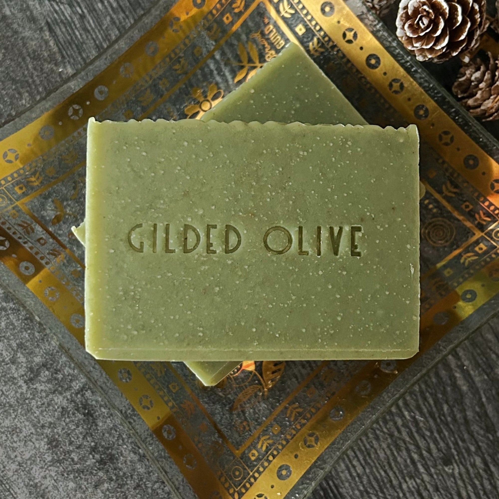 Pine Forest Handmade Soap with 'Gilded Olive' branding on a decorative surface.