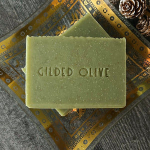Pine Forest Handmade Soap with 'Gilded Olive' branding on a decorative surface.