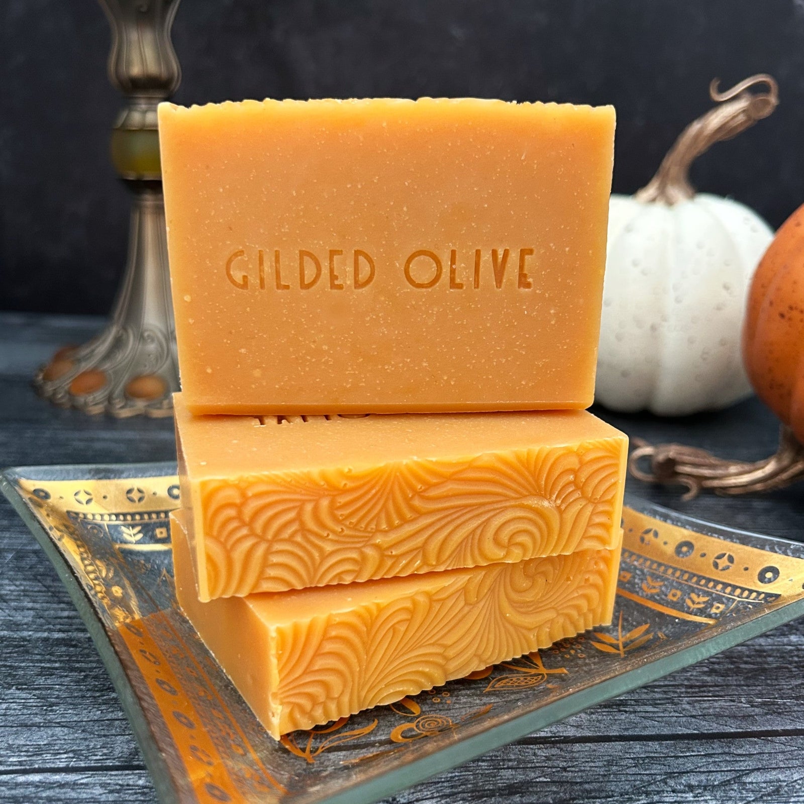 Pumpkin Spice Handmade Soap on gold, vintage dish with pumpkins in the background.