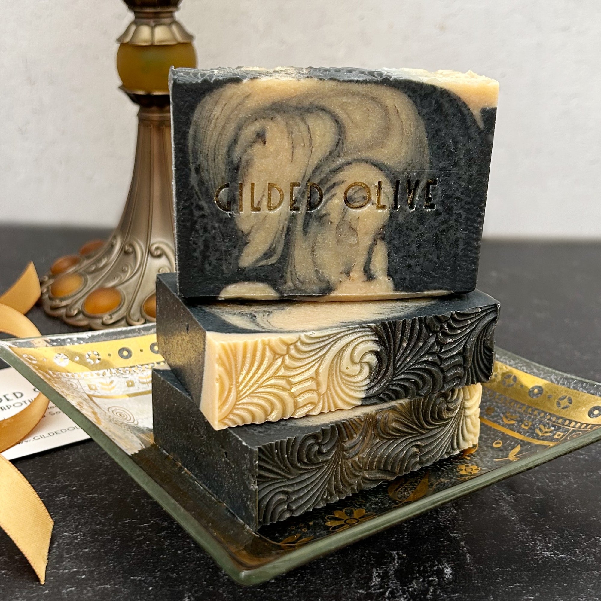 Three bars of Sacred Embers Handmade Soap on a gilded dish.