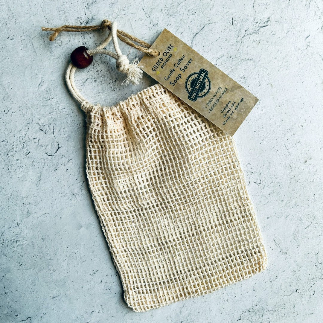 Soft, textured cotton soap bag with a tag on a light gray background