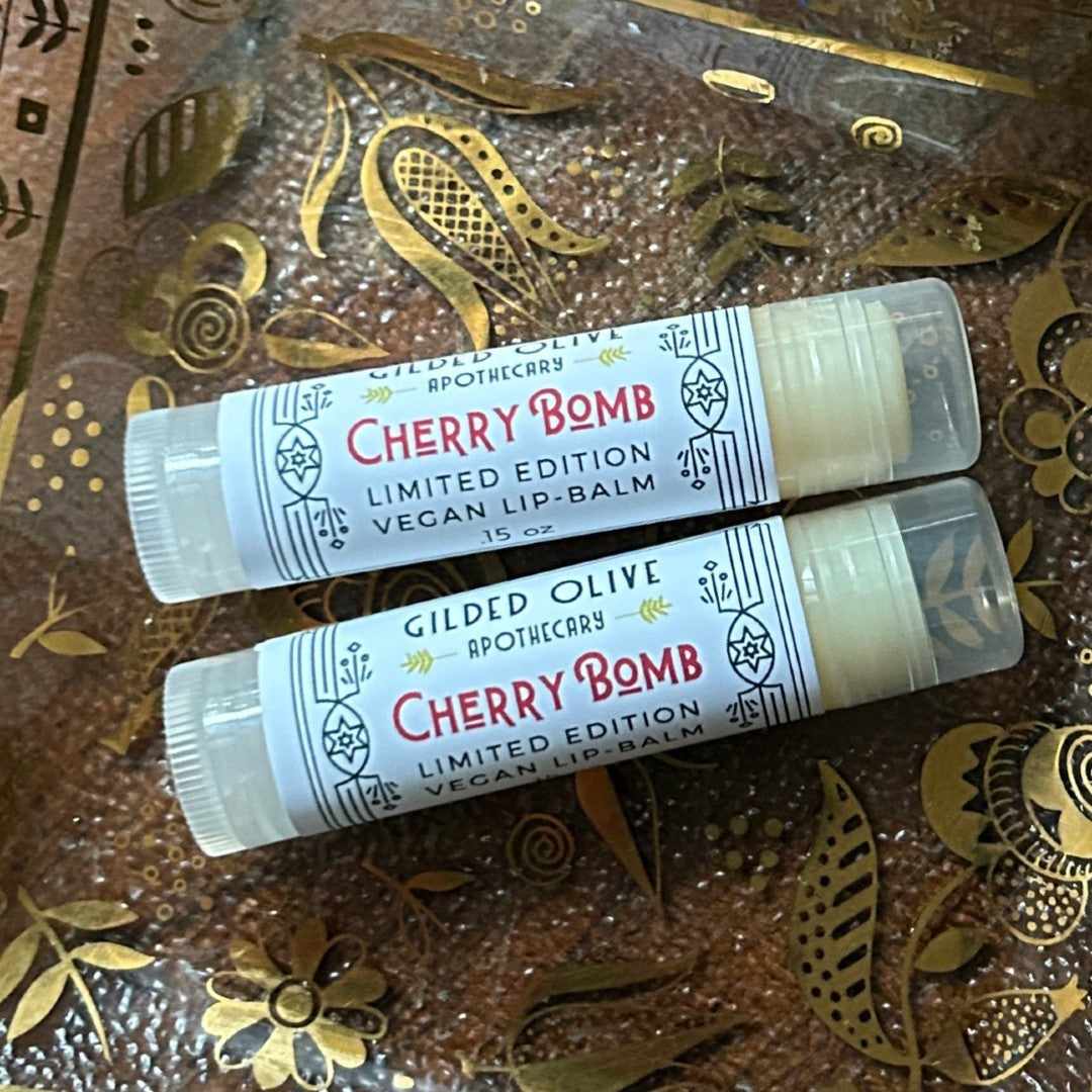 Cherry Bomb Vegan Lip Balm on a vintage glass dish