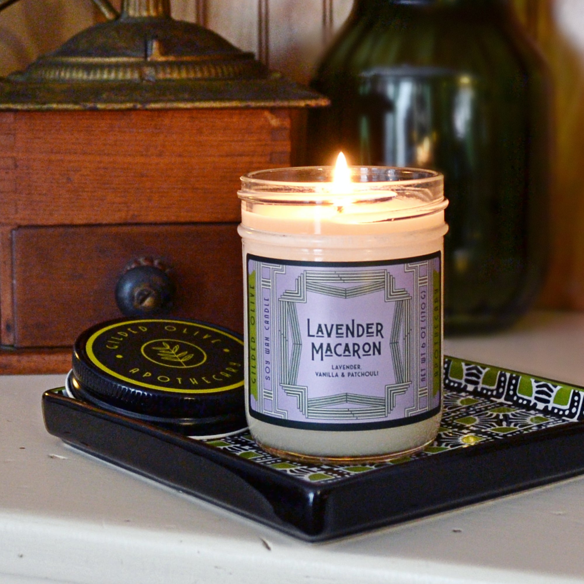Lit Lavender Macaron Soy Candle with vintage inspired Art Deco label